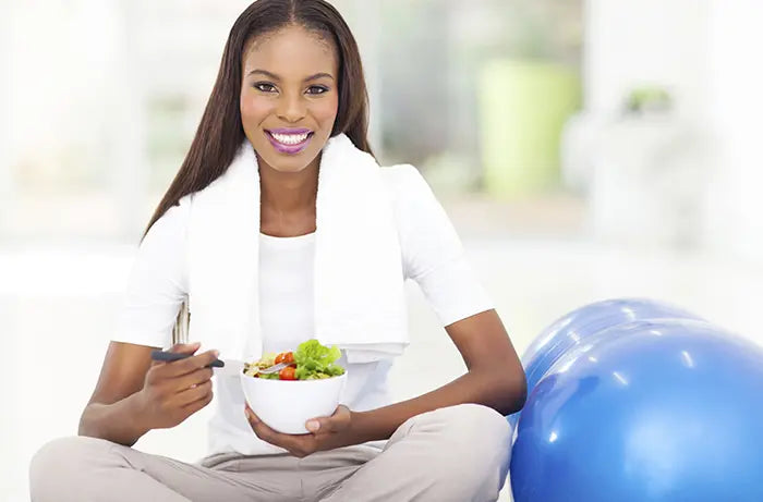 Woman enjoying healthy salad as part of lifestyle plan coaching package