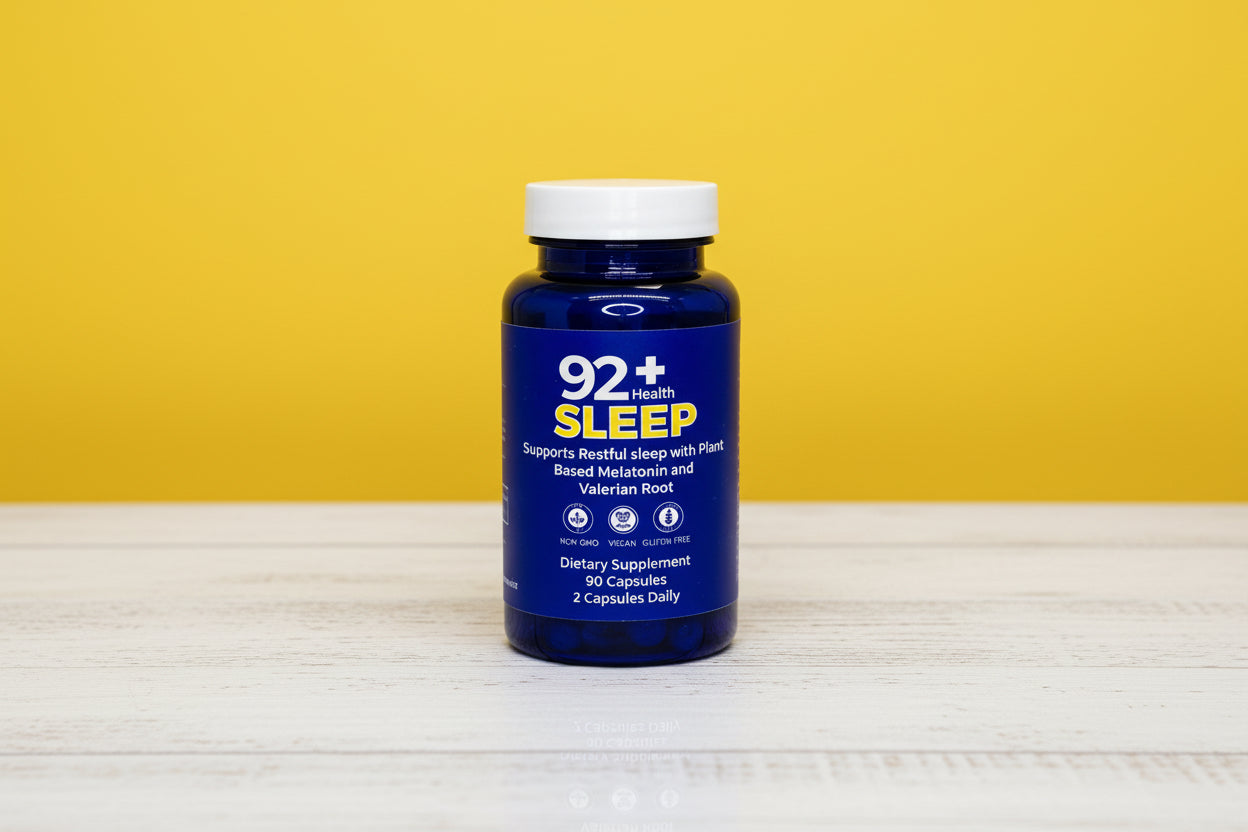 92+ Sleep Support natural sleep aid capsules with melatonin and valerian root in blue bottle on wooden surface