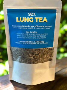92+ Lung Tea packaging on a wooden table, highlighting benefits for respiratory health and lung function.