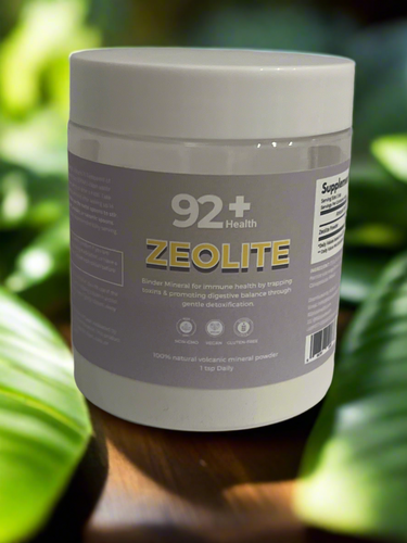 Zeolite supplement powder jar on leafy background.