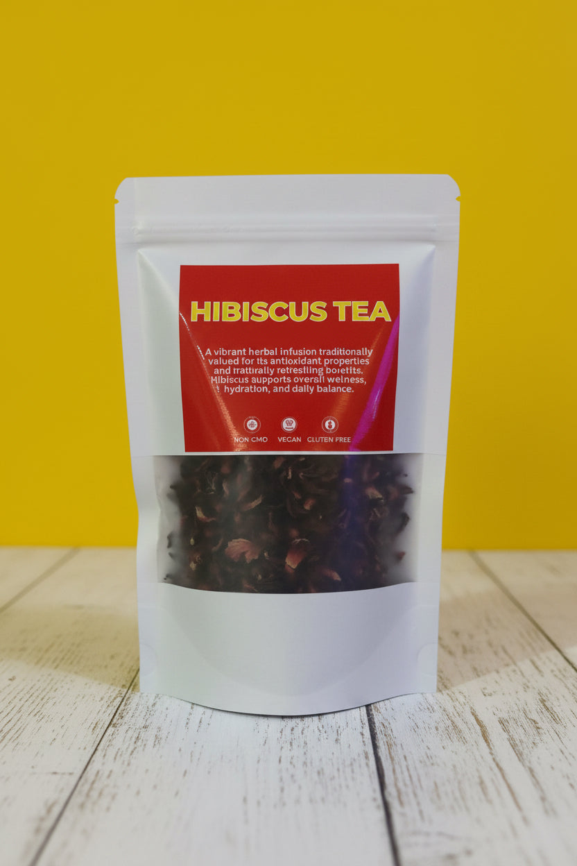 Cup of vibrant ruby-red hibiscus tea made from premium dried hibiscus flowers with fresh hibiscus blossoms nearby